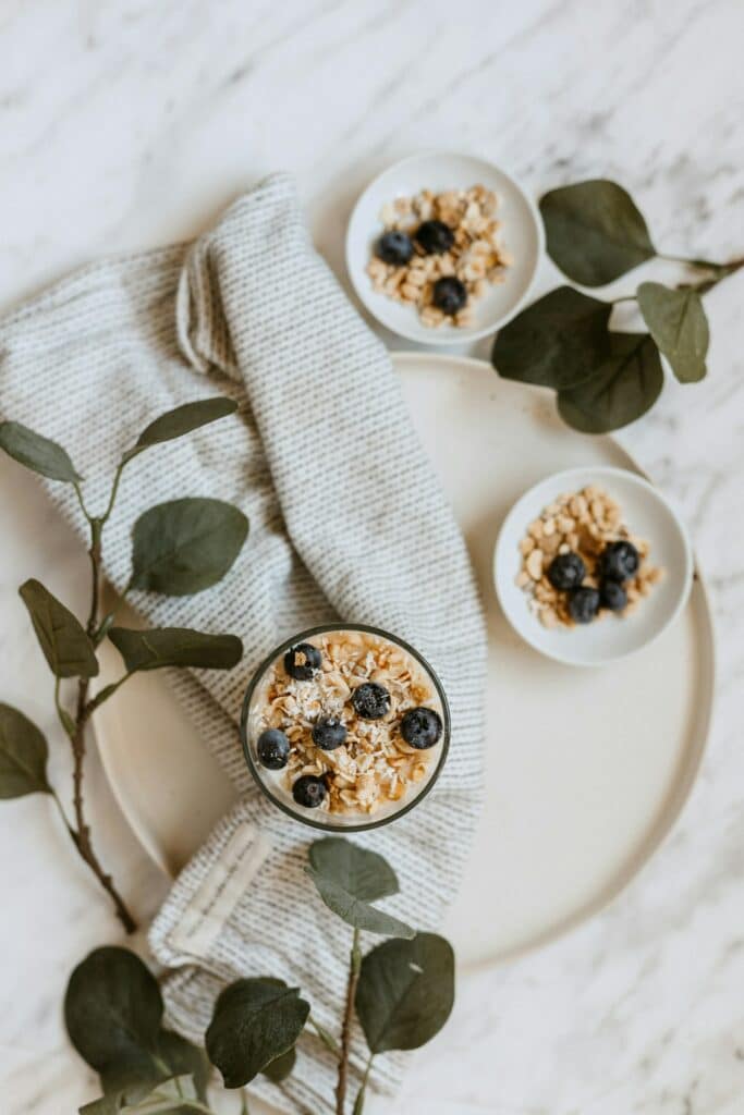 a bowl of oatmeal with blueberries and coconut flakes