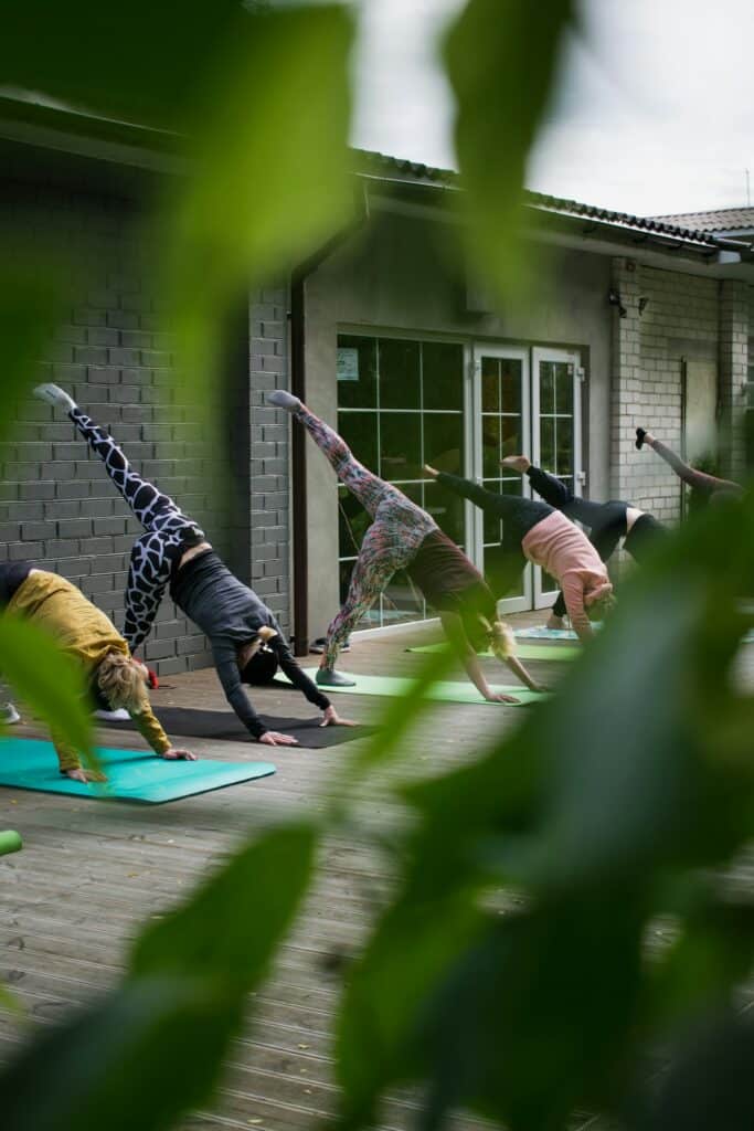 a group of people doing yoga outside