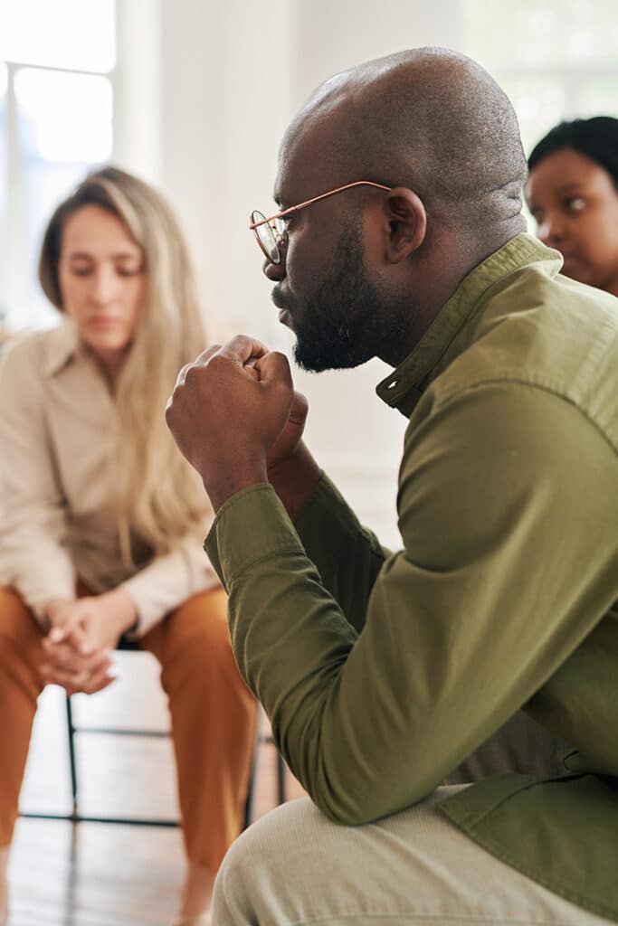 People participate in group therapy in a drug rehab program.