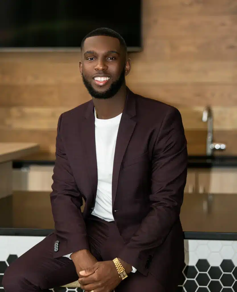 a man in a suit sitting on a counter