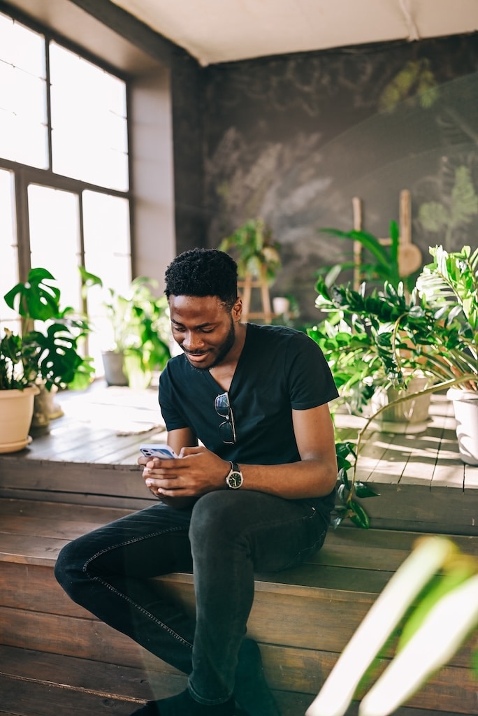 Man sitting on the porch of a sun room, representing healing at our North Carolina treatment center.
