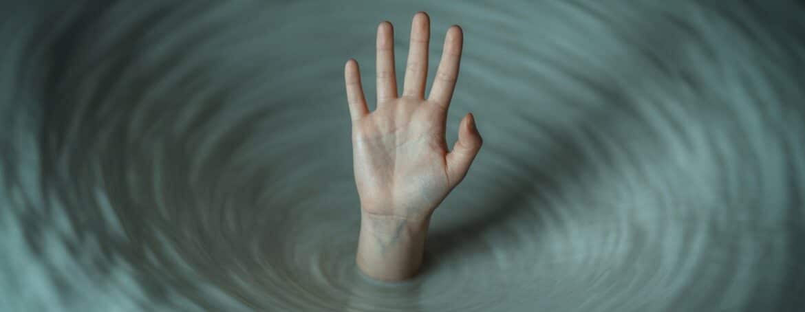 hand reaching out of water or storm, representing addiction