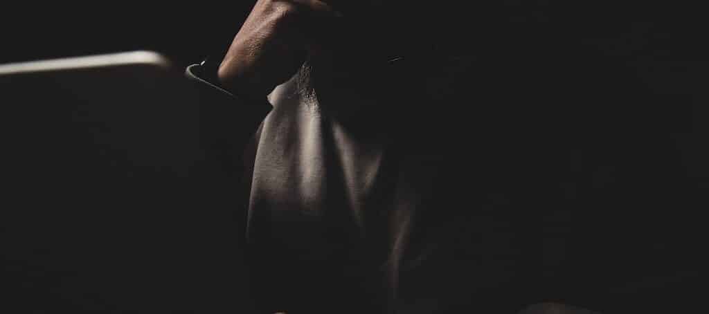 Anonymous man at a laptop at night.