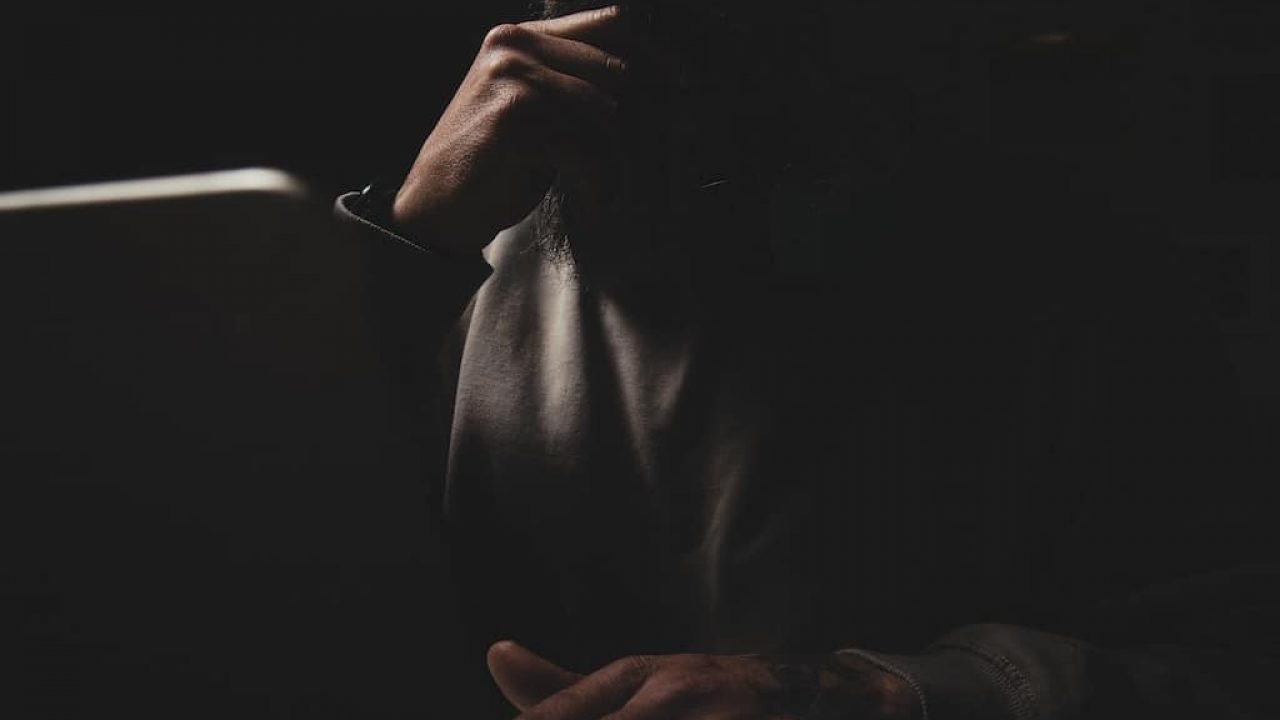Anonymous man at a laptop at night.