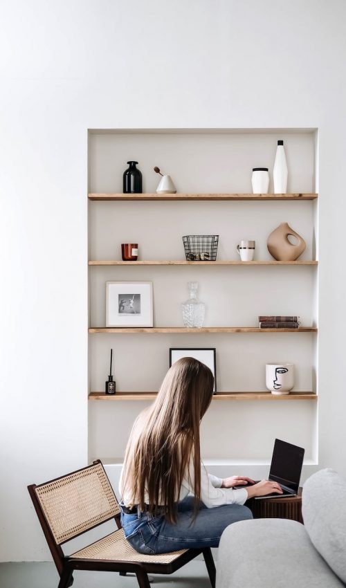 Woman sitting at her laptop researching different addiction treatment programs in North Carolina.